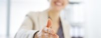 Closeup on happy business woman stretching hand for handshake